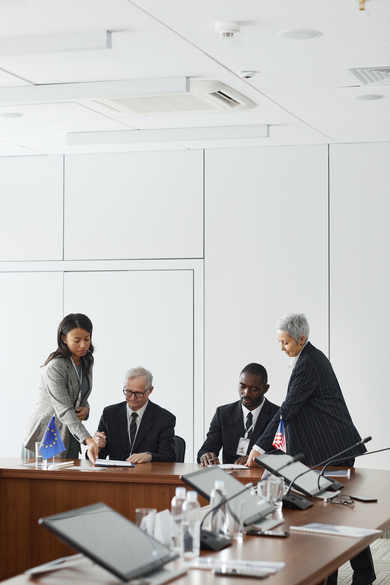 Men Sitting at a Table Beside Women